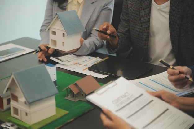 Photo team of architectures and businessmen discussing and brainstorming on floor plan modification for real estate investment and housing development project