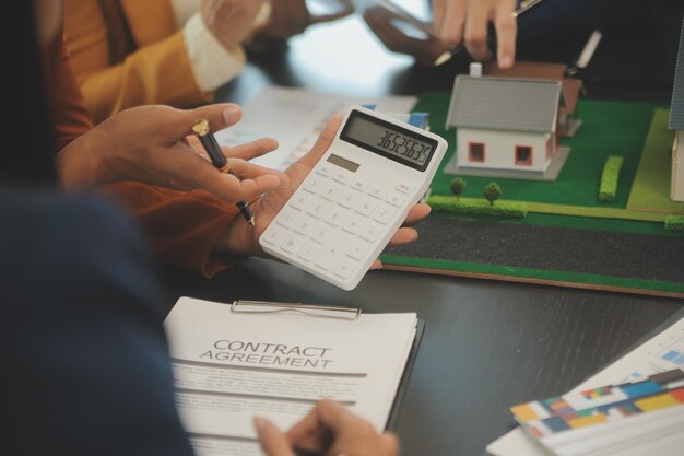 Photo team of architectures and businessmen discussing and brainstorming on floor plan modification for real estate investment and housing development project