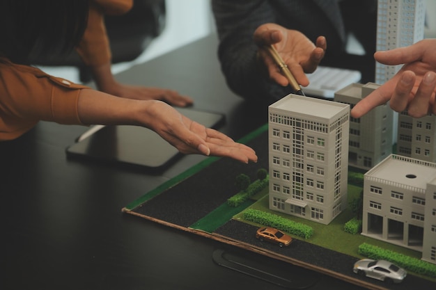 Team of architectures and businessmen discussing and brainstorming on floor plan modification for real estate investment and housing development project