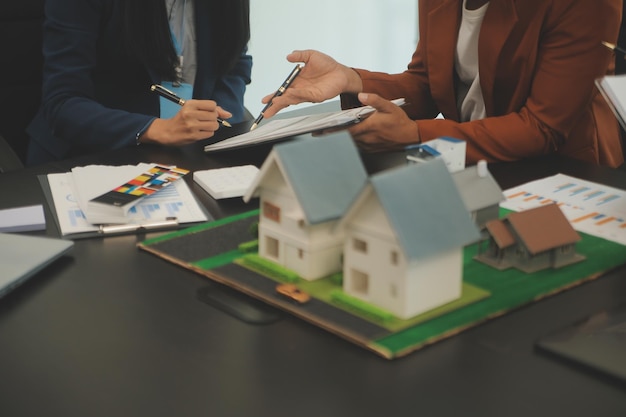 Team of architectures and businessmen discussing and brainstorming on floor plan modification for real estate investment and housing development project