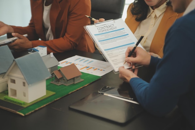 Photo team of architectures and businessmen discussing and brainstorming on floor plan modification for real estate investment and housing development project