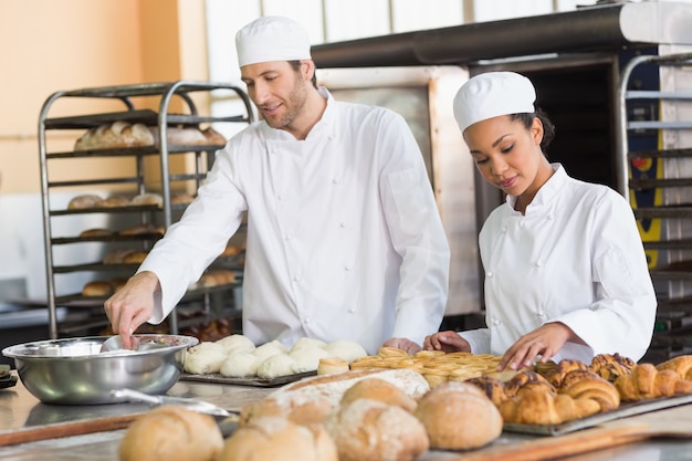 Team of bakers preparing dough and pastry