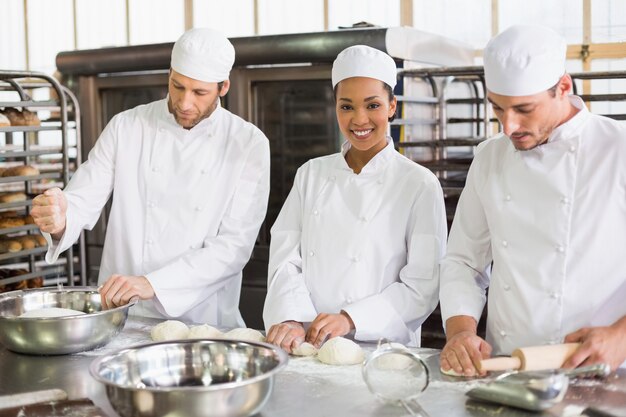 Team of bakers preparing dough