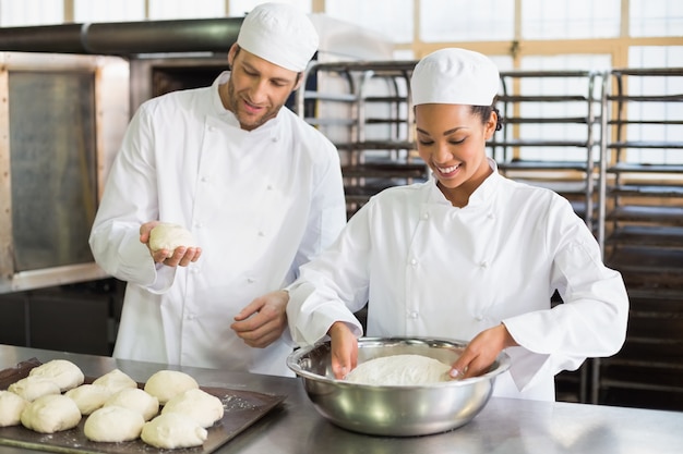 Team of bakers preparing dough