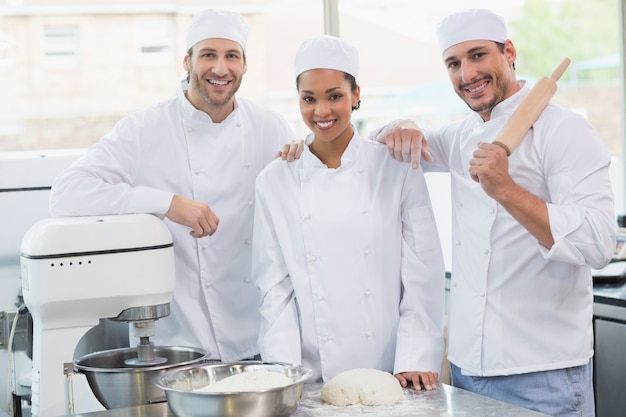 Team of bakers smiling at camera