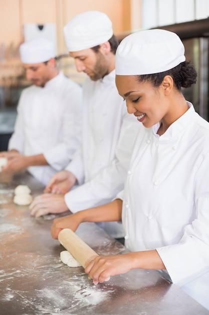 Team of bakers working at counter 