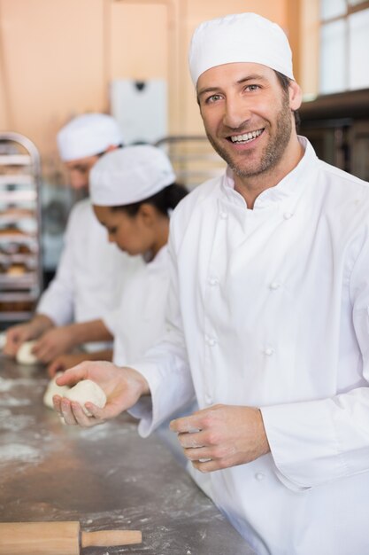 Team of bakers working at counter 