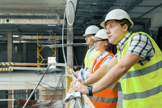 Team of builders, engineers and architects at construction site