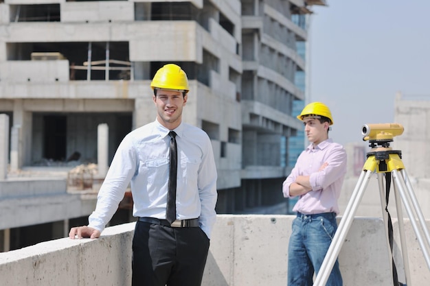 Team of business people in group, architect and engeneer  on construciton site check documents and business workflow on new building