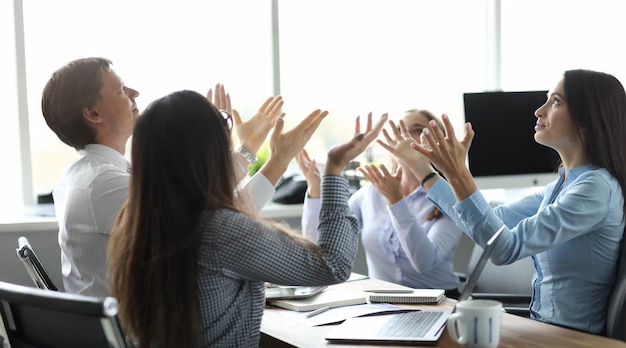 team of business people raise hand from office background