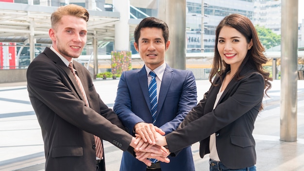 team of business people smart man and woman join the hand to show teamwork