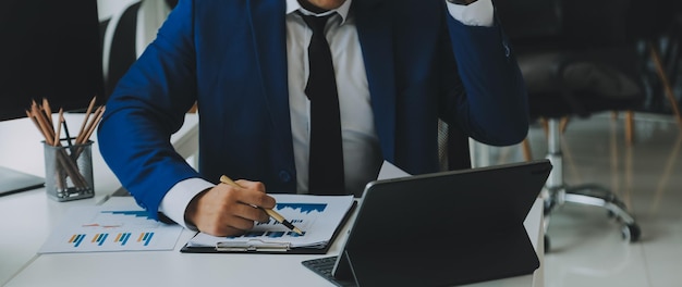 Photo team of business people working together in the meeting room office teamwork background charts and graphs banner double exposure successful teamworkbusiness planning concept