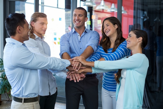 Team of businesspeople forming handstack