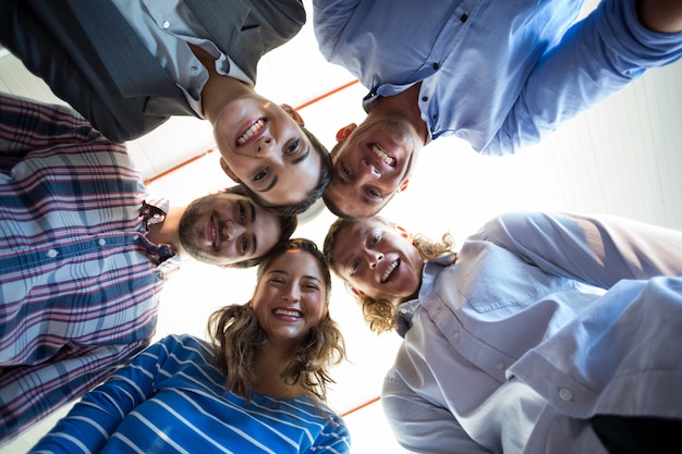 Team of businesspeople forming huddle