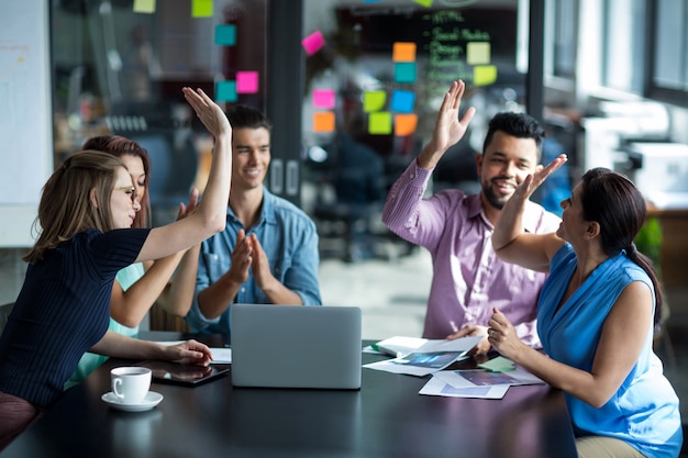 Team of businesspeople giving high five