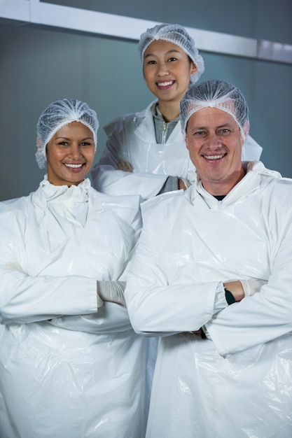 Team of butchers standing with arms crossed