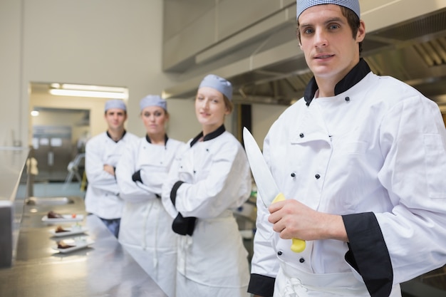 Team of Chef&#039;s with one holding a knife