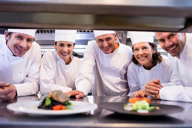 Team of chefs smiling at camera