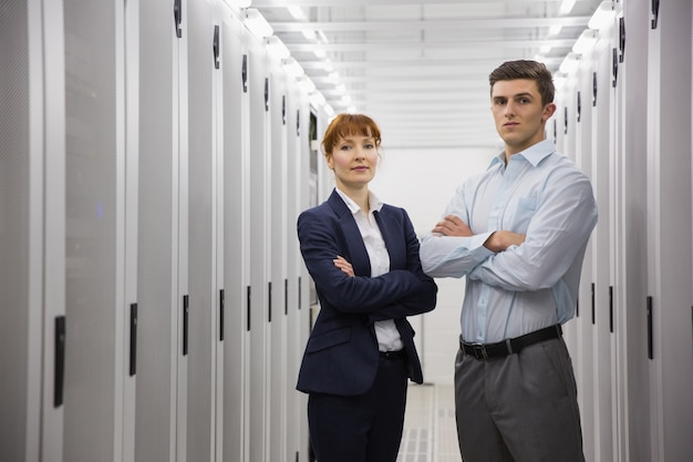 Team of computer technicians looking at camera