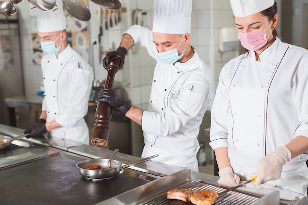 Team of cooks cooking in a restaurant