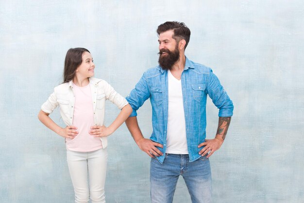 Team of dad Bearded hipster man and adorable child girl We are team Family team Father and daughter teammates Parenthood and childhood Fathers day concept Trust and support Best friends