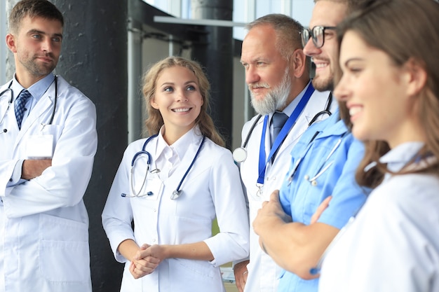 Team of different doctors having conversation in hospital.