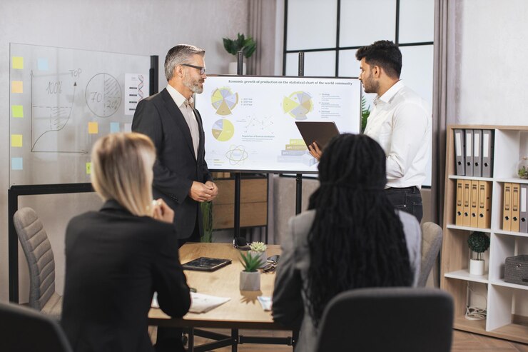 Photo team of diverse attentive mixed race business people listening their middle aged male bearded chief