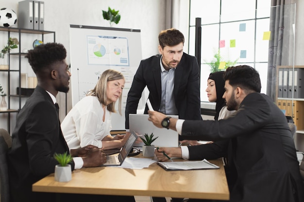 Team of diverse company workers having briefing at office