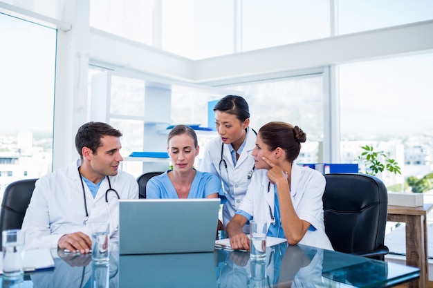 Team of doctors looking at laptop