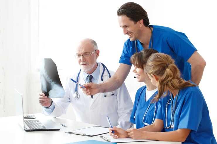 Team of doctors looking at x-ray