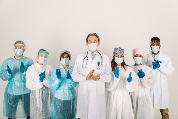 Team of doctors and nurses wearing disposable protection suits and face masks for fighting Covid19