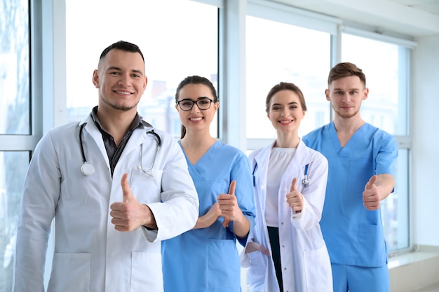 Team of doctors showing thumb-up in clinic