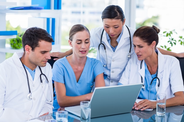 Team of doctors working on laptop