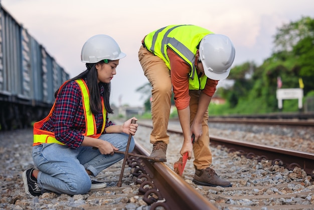 Team engineer holding wrench for repair working on train site, safety, civil, workers