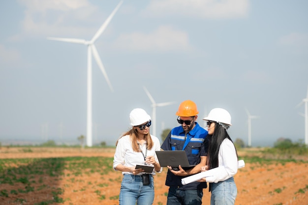 Photo team of engineers and architects working on wind turbines in a wind farm