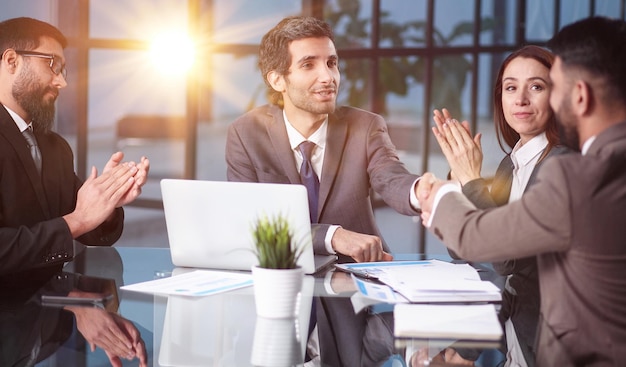 Team of Engineers Gather Around Conference Table