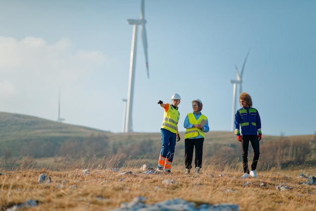 Photo a team of engineers and workers oversees a wind turbine project at a modern wind farm working