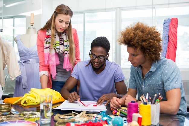 Team of fashion designers sketching