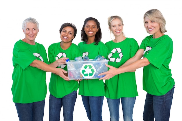 Team of happy female environmental activists holding box of recyclables