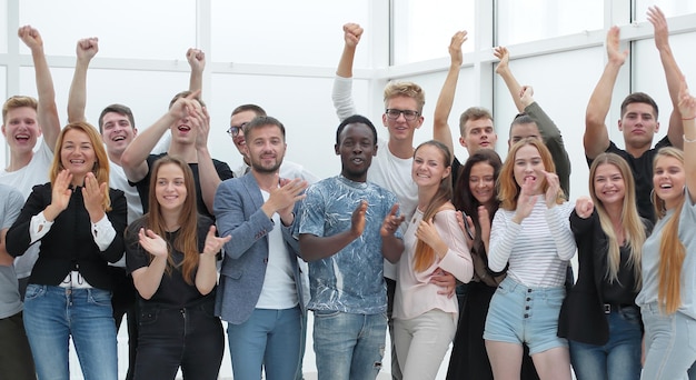 Team of happy young people showing their success photo with copy space