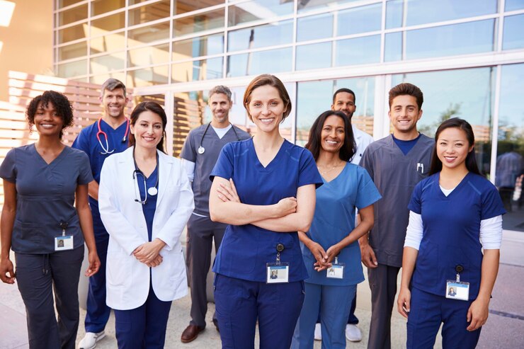 Photo team of healthcare workers with id badges outside hospital
