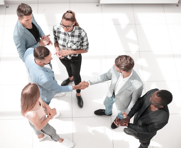 Team leaders meet multiracial interns in office explaining new job