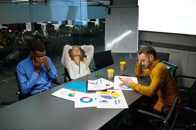 Team of managers at table, conference in IT office