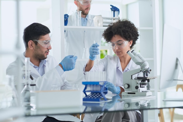 Photo team of medical research scientists working on generation experimental drug