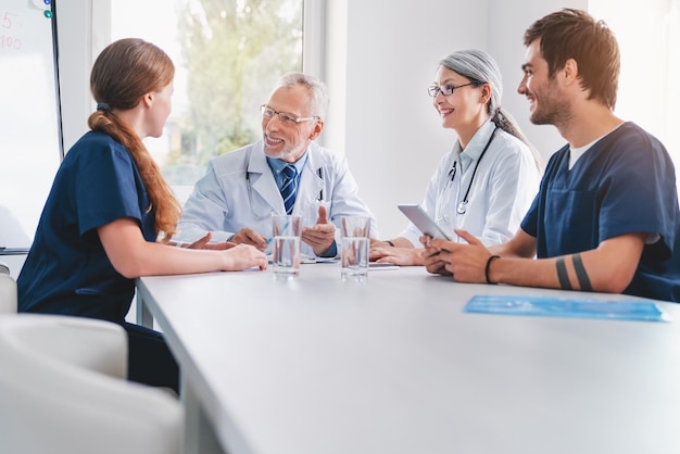 Team of medical staff having morning meeting in boardroom