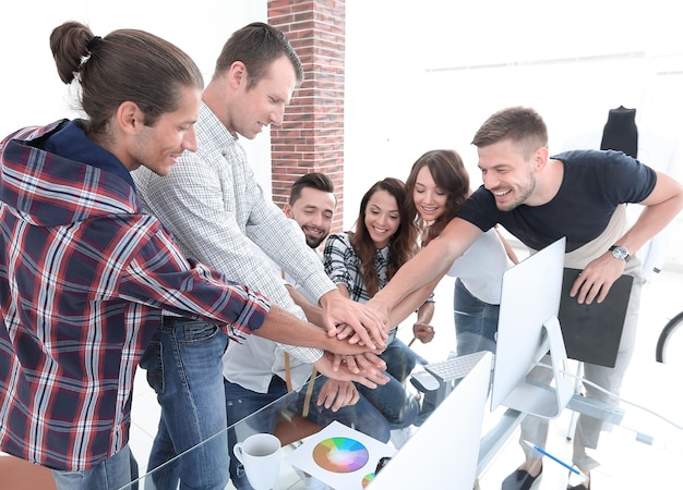 Team meeting are stacked hands in creative office