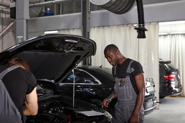 Team of men working in auto service shop