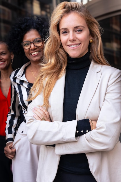 team of multiracial and diverse businesswomen posing in a row smiling for the camera