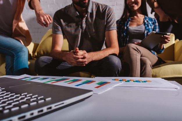 Photo team of people work together on company statistics in office