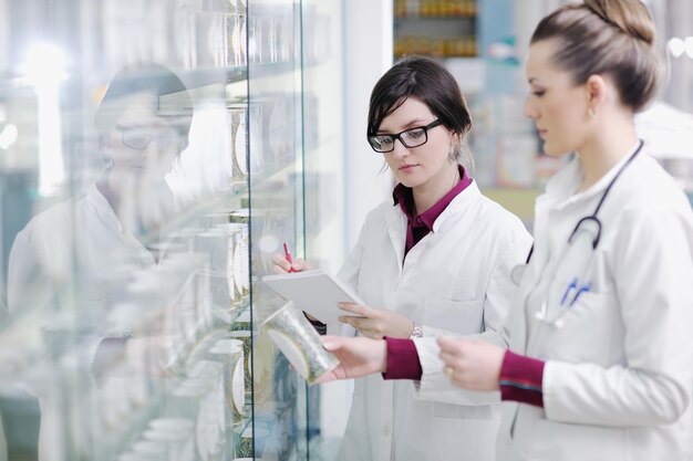 team of  pharmacist chemist woman group  standing in pharmacy drugstore